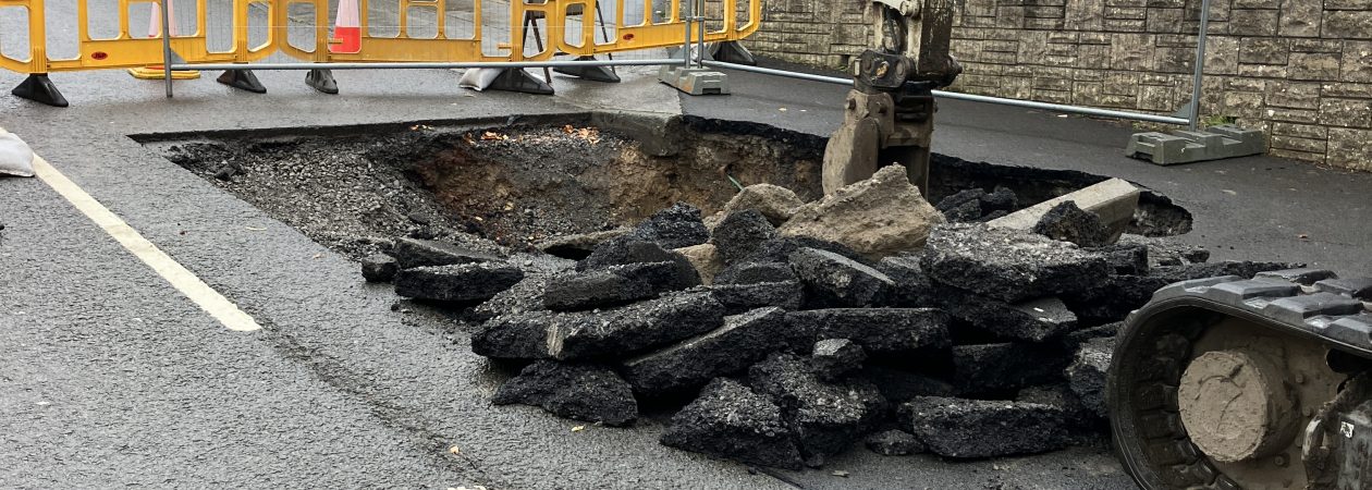 A JCB digging up the road